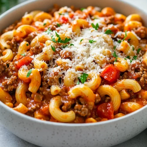 Easy American Goulash Recipe For A Healthy One-Pot Dinner 2 Bowl Of American Goulash Garnished With Parmesan Cheese And Parsley On A Light Countertop