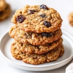 Stack Of Cinnamon Raisin Oatmeal Cookies On A White Plate, Showcasing Crispy Edges And Chewy Centers