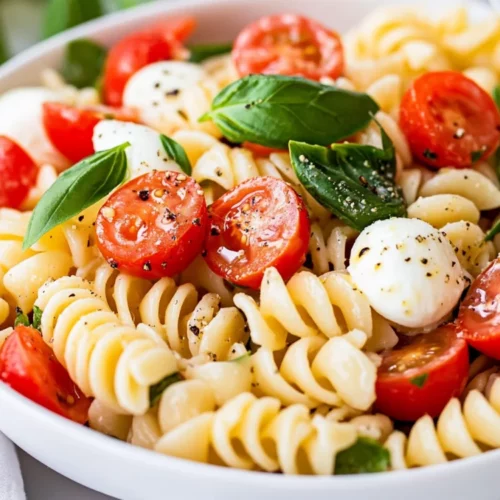 Healthy Caprese Pasta Salad: A Quick And Nourishing Recipe 2 Healthy Caprese Pasta Salad In A White Bowl With Cherry Tomatoes, Mozzarella Pearls, Fresh Basil, And Light Dressing.