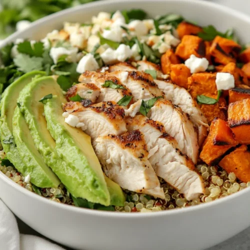 Healthy Chicken Quinoa Salad: A Protein-Packed Delight In 5 Minutes 2 Healthy Chicken Quinoa Salad In A White Bowl Topped With Avocado, Feta, And Sunflower Seeds