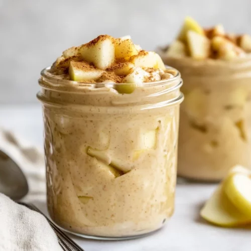 Simple And Delicious High-Protein Apple &Amp; Peanut Butter Overnight Oats 2 Creamy High-Protein Apple And Peanut Butter Overnight Oats In A Jar, Topped With Fresh Apple Slices, Peanut Butter Swirl, And Cinnamon.