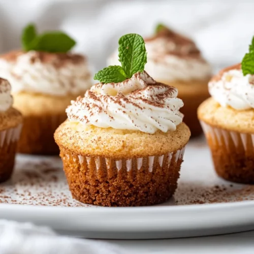 Keto Cheesecake Cupcakes: Low Carb &Amp; Gluten-Free Dessert Perfection 2 Keto Cheesecake Cupcakes Topped With Whipped Cream And Cocoa Powder, Displayed On A White Plate.