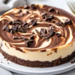Low-Carb Chocolate Swirl Cheesecake On A White Plate, Garnished With Chocolate Shavings And Nuts, Velvety And Creamy Texture