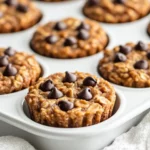 Peanut Butter Chocolate Chip Oatmeal Cups In A Muffin Pan, Showcasing Melty Chocolate Chips And A Golden Top