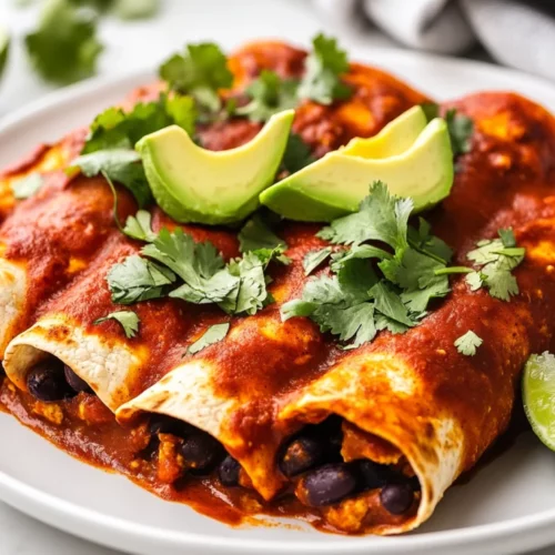 The Best Vegan Enchiladas Recipe: Easy, Healthy, And Delicious 2 Delicious Vegan Enchiladas Topped With Red Sauce, Fresh Avocado, And Cilantro On A White Plate