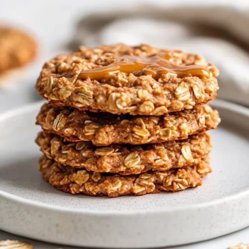 Vegan No-Bake Cookies: A Quick And Easy Healthy Treat 2 A Stack Of Vegan No-Bake Cookies On A White Plate Drizzled With Almond Butter And Sprinkled With Cinnamon, On A Clean Background