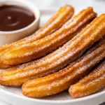 Golden Crispy Air Fryer Churros On A White Plate With Cinnamon Sugar, Served With A Chocolate Sauce For Dipping