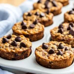 Batch Of Chocolate Chip Baked Oatmeal Cups Arranged In A White Tray, Showing Melted Chocolate And Golden Edges