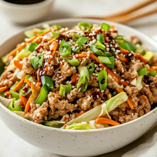 The Best Egg Roll In A Bowl Recipe (Quick, Easy And Healthy!) 2 Bowl Of Egg Roll In A Bowl Topped With Green Onions And Sesame Seeds On A Light Background
