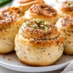 Everything Bagel Cream Cheese Rolls On A White Plate, Garnished With Scallions And Everything Bagel Seasoning