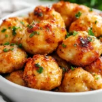 Garlic Butter Chicken Bites In A White Bowl Garnished With Parsley And Glistening Garlic Sauce