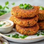 Crispy Gluten Free Falafel Patties On A White Plate Garnished With Parsley And Served With Tahini Sauce