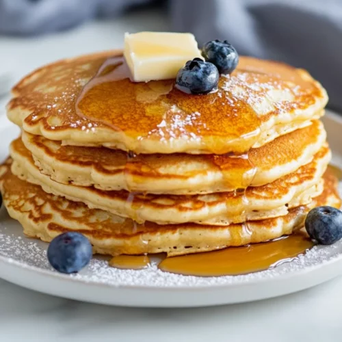 Fluffy And Easy Gluten Free Pancakes Recipe For Every Morning 2 Fluffy Gluten Free Pancakes Stacked On A White Plate, Topped With Butter And Blueberries, Drizzled With Maple Syrup
