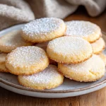 Plate Of Gluten-Free Shortbread Cookies Lightly Dusted With Powdered Sugar On A White Plate