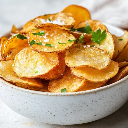 Crispy And Healthy Homemade Gluten-Free Potato Chips Recipe 2 Bowl Of Crispy Homemade Gluten-Free Potato Chips Garnished With Fresh Parsley On A White Background