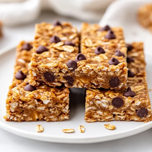 Healthy Homemade Granola Bars Packed With Peanut Butter And Chocolate 2 Homemade Granola Bars On A White Plate, Showcasing Layers Of Oats, Chocolate Chips, And Pepitas