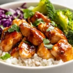 Delicious Hot Honey Chicken Bowl Filled With Chicken, Rice, Roasted Broccoli, And Purple Cabbage Garnished With Parsley