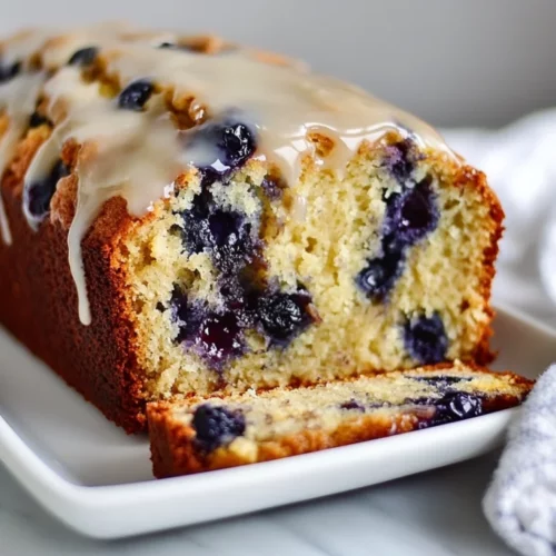 Moist And Healthy Lemon Blueberry Banana Bread Recipe 2 Slice Of Lemon Blueberry Banana Bread On A White Plate Showing Moist Texture And Lemon Glaze Drizzle