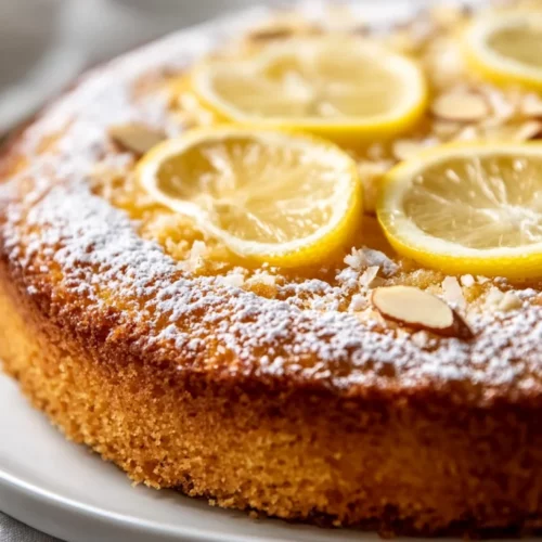 Lemon Coconut Almond Cake: A Healthy And Moist Delight 2 Lemon Coconut Almond Cake On A White Plate Garnished With Powdered Sugar And Lemon Slices