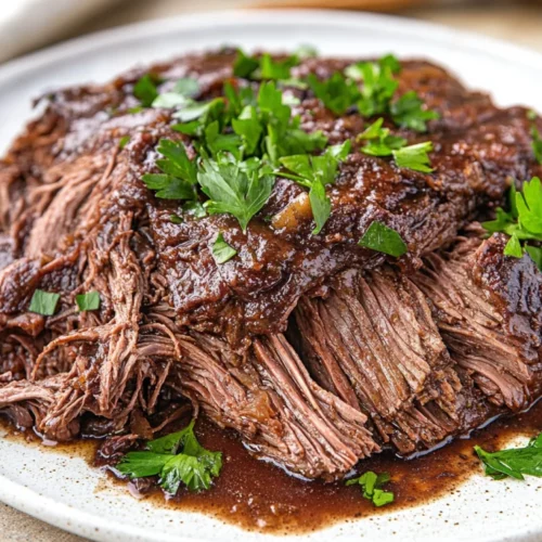 Mississippi Pot Roast Recipe: Slow Cooker Perfection For Healthy Comfort Food 2 Mississippi Pot Roast Recipe Served On A White Plate, Garnished With Parsley And Peperoncinis, Showcasing Tender, Juicy Texture.