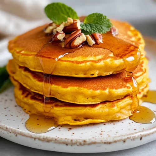 Pumpkin Pancakes: Fluffy, Healthy, And Irresistible Breakfast Treats 2 Fluffy Pumpkin Pancakes Stacked On A White Plate, Drizzled With Maple Syrup And Topped With Pecans.