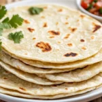 Soft Quinoa Tortillas On A White Plate, Garnished With Cilantro And Served With Salsa