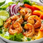 Vibrant Shrimp Fajita Salad With Shrimp, Bell Peppers, And Cilantro In A White Bowl With Lime Wedges