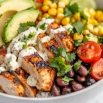 Colorful Street Corn Chicken Bowl With Grilled Chicken, Corn Salad, Rice, And Fresh Toppings On A White Plate.