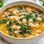 Bowl Of Tuscan White Bean Soup Garnished With Fresh Parsley And A Drizzle Of Olive Oil