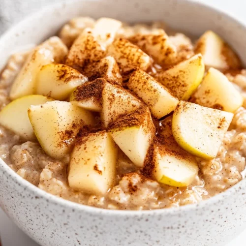 Apple Cinnamon Oatmeal: Healthy &Amp; Delicious Stovetop Recipe 2 Bowl Of Apple Cinnamon Oatmeal Topped With Apple Slices, Cinnamon, And Maple Syrup On A White Background