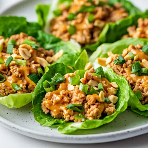 Delicious And Healthy Asian Chicken Lettuce Wraps Recipe 2 Delicious Asian Chicken Lettuce Wraps Filled With Ground Chicken And Garnished With Sliced Green Onions And Crushed Peanuts.