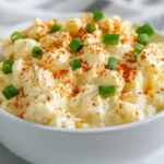 Bowl Of Best Egg Salad With Green Onions And Paprika On A White Towel