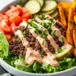 Big Mac Inspired Burger Bowls With Ground Beef, Fresh Veggies, And Creamy Sauce Served With Sweet Potato Fries