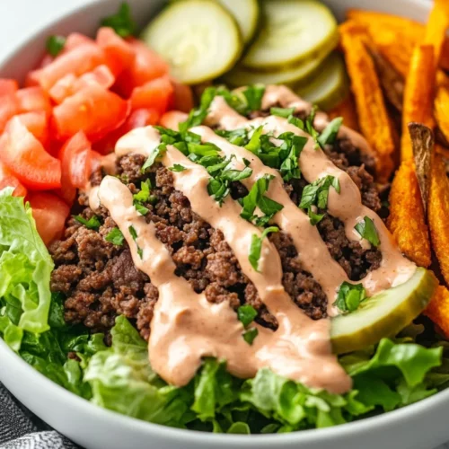 Big Mac Inspired Burger Bowls With Ground Beef, Fresh Veggies, And Creamy Sauce Served With Sweet Potato Fries