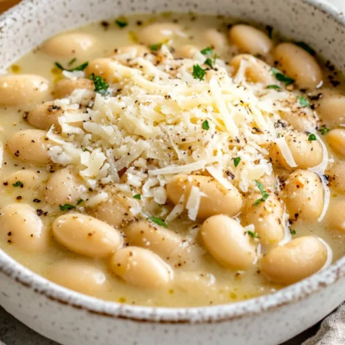 Deliciously Creamy Cacio E Pepe White Beans In Just 15 Minutes 2 Bowl Of Cacio E Pepe White Beans Topped With Parmesan And Black Pepper, Served On A Neutral Background