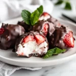Chocolate Strawberry Cottage Cheese Dessert Clusters Coated In Chocolate On A White Plate With Fresh Mint Leaves.