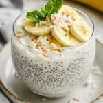 Creamy Coconut Chia Pudding In A Glass Cup Topped With Banana Slices And Shredded Coconut