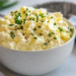Cottage Cheese Egg Salad In A White Bowl, Garnished With Chives And Pepper On A Neutral Background