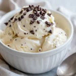Creamy Cottage Cheese Ice Cream In A White Bowl Topped With Chocolate Chips And A Spoon