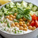 Vibrant Cottage Cheese Salad Bowl Topped With Chickpeas And Fresh Herbs, Served With Lemon Wedges