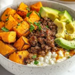 Cottage Cheese Sweet Potato Bowl Topped With Ground Beef, Avocado, And Hot Honey, In A White Bowl On A Neutral Background