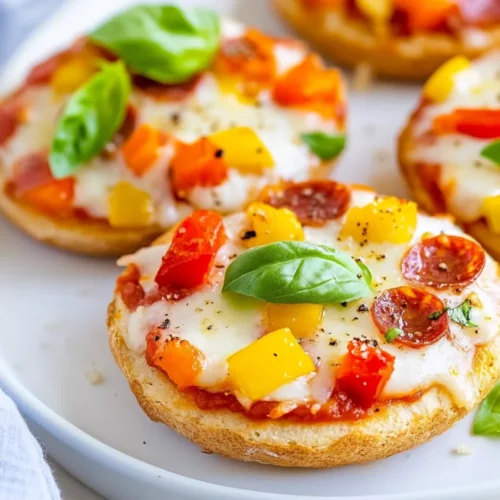 The Best English Muffin Pizza Recipe: Quick, Easy And Healthy 2 Delicious English Muffin Pizza Topped With Melted Cheese And Colorful Veggies, Served On A White Plate.