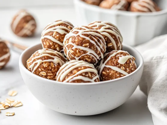 Healthy Gingerbread Protein Balls For A Perfect Snack 2 Chewy Gingerbread Protein Balls Drizzled With White Chocolate In A White Bowl, Showcasing A Rustic Texture