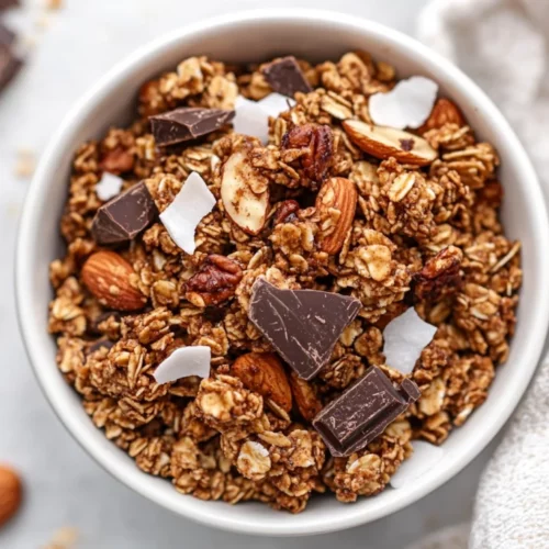 Grain-Free Banana Bread Granola Recipe With Healthy Clusters 2 Bowl Of Grain-Free Banana Bread Granola With Chewy Clusters Of Nuts And Dark Chocolate On A Neutral Table