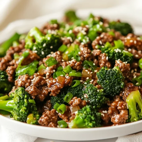 Ground Beef And Broccoli Stir Fry For A Healthy, Quick Dinner 2 Delicious Ground Beef And Broccoli Stir Fry On A White Plate, Garnished With Sesame Seeds And Green Onions.