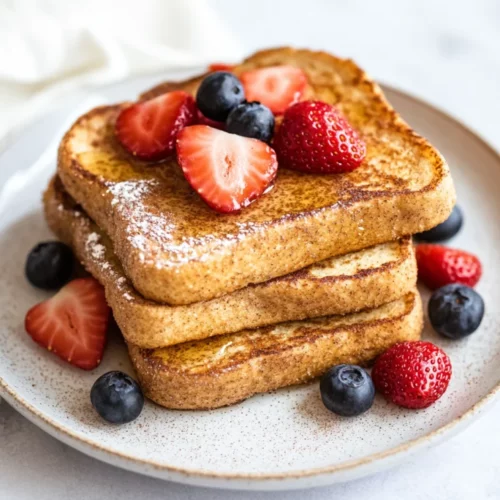 Healthy Protein French Toast: A Quick And Nutritious Breakfast 2 Fluffy Healthy Protein French Toast On A White Plate, Topped With Berries And Almond Butter, Dusted With Cinnamon