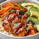 Bowl Of Hot Honey Chicken Bowls Featuring Glazed Chicken, Rice, Vegetables, And Avocado Slices, Garnished With Parsley