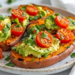 Delicious How To Make Sweet Potato Toast Topped With Smashed Avocado And Cherry Tomatoes On A White Plate