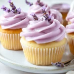 Lavender Cupcakes Topped With A Lavender Glaze And Sugared Lavender Sprigs On A White Plate