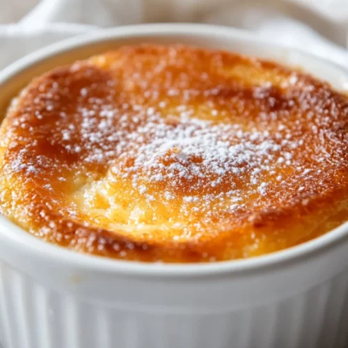 Orange Ginger Self-Saucing Pudding: A Healthy, Zesty Dessert 2 Warm Orange Ginger Self-Saucing Pudding In A White Dish, Garnished With Icing Sugar And Crystallized Ginger